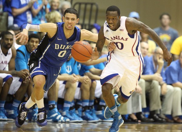 Kansas guard Tyshawn Taylor is fouled fighting for a loose ball with Duke guard Austin Rivers during the first half Wednesday, Nov. 23, 2011 at the Lahaina Civic Center.