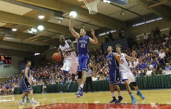 Kansas guard Tyshawn Taylor looks for a shot as he is defended by Duke forward Miles Plumlee during the first half on Wednesday, Nov. 23, 2011 at the Lahaina Civic Center.