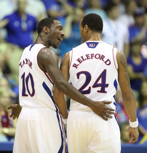 Kansas guard Tyshawn Taylor gives words of advice to teammate Travis Releford after a first-half turnover against Duke on Wednesday, Nov. 24, 2011.