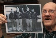 In this Dec. 1, 2011 photo, Maj. Thomas Griffin holds a photo at his home in Cincinnati, showing the flight crew of the U.S. Army Air Force B-25B Mitchell bomber on which he was a navigator for Doolittle's raid on Japan in 1942. Griffin, who was a lieutenant at the time, is pictured at left, along with, left to right, pilot Lt. Harold Watson, T/Sgt. Eldred Scott, Lt. James Parker, and Sgt. Wayne Bissell. (AP Photo/Al Behrman)