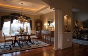 Stylish Staging outfitted Trish Van Vilet's formal dining room with tons of small, homey details, like ornaments in jars on the table, decor pics on the arms of the light fixture and garlands above the windows.