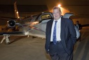 Charlie Weis, formerly the offensive coordinator at Florida, gets off the Kansas University plane at the Lawrence Airport on Thursday night around 8:30 p.m. Weis has agreed to become the 37th football coach in KU history. KU will hold a press conference to introduce Weis on Friday.