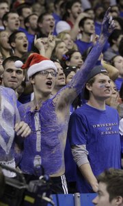 A KU student — one of a group of students spelling out "Go KU Jayhawks!" — puts the exclamation point on Kansas' 78-67 victory over No. 2-ranked Ohio State University at Allen Fieldhouse, Dec. 10, 2011.