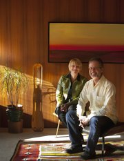 Lawrence residents Tom Harper and Terri Erickson-Harper are pictured Dec. 9 in their Lawrence home that was built in 1952 and designed by John C. Morley. A defining feature throughout the majority of the home are the Philippine mahogany walls. Harper is one of the founding members of the Lawrence Modern group.
