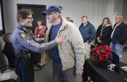 Retiring Lawrence police sergeant Susan Hadl jokes with former Lawrence police officer Don "Red Dog" Gardner at a retirement ceremony held for Hadl recognizing her for her years of service with the Lawrence Police Department on Friday, Dec. 16, 2011.