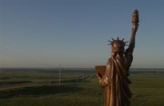 "Liberty of the Plains," a small copy of the Statue of Liberty, along U.S. 281 south of Smith Center, Kan., faces south overlooking farmland and pastures and the community of Harlan, Kan., in this file photo.