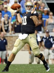 In this Sept. 3, 2011, file photo, Notre Dame quarterback Dayne Crist throws against South Florida in South Bend, Ind.