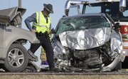 A Kansas Highway Patrol trooper inspect the scene of an accident that sent five people to the hospital Tuesday, Jan. 3, 2012 on Kansas Highway 56.
