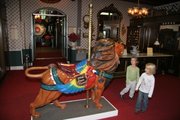 A carousel lion at the Patee House Museum in St. Joseph, Mo., draws the attention of young visitors.