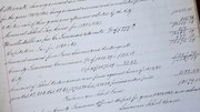 A hand-written page from a mid-1800s city record book lists several bills presented to the City Council. Included are bills for a $5 burial of a pauper, a 75 cent charge for burying a heifer and the payment of $2.70 for a Mr. Otis Potter, “for hauling dirt on Massachusetts Street.”