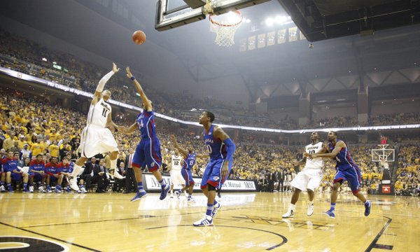 Missouri guard Michael Dixon puts up a shot over Kansas guard Travis Releford during the first half on Saturday, Feb. 4, 2012 at Mizzou Arena.