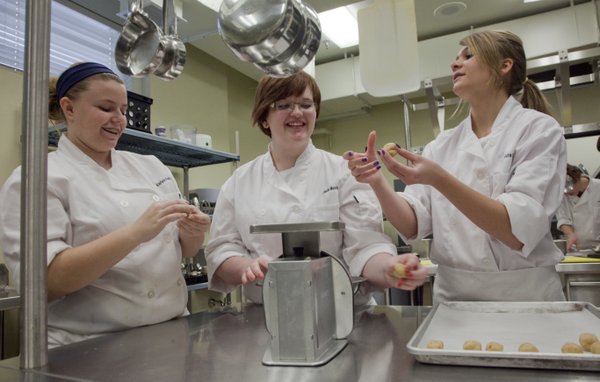 Eudora High School culinary arts students, from left, Kaylyne Perkins, Claudia Moody and Alexandra Bock, prepare homemade tater tots. The students, all sophomores, hand-formed tater tots from homemade dough before baking the majority and frying a few to see the difference.