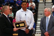 Leavenworth graduate and former Kansas University player Wayne Simiem, Jr., center, was inducted in the Kansas State High School Activities Association Hall of Fame before a sub-state game Thursday at Leavenworth.
