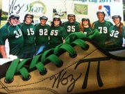 This shoe, once worn by Apple co-founder Steve Wozniak, is part of a pair of sneakers being auctioned during the Pi Day Gala March 14. Wozniak, far left, wears jersey number 3.14.