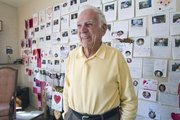 Robert Ford stands in his living room that has one complete wall decorated with Valentine cards in College Hill on Feb. 16. At age 98, the only thing Wichitan Robert Ford told his family he wanted was some cards for Christmas, and he now is a pen pal to students in Georgia.