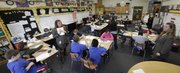 Denise Johnson could use a clone of herself as the teacher of 31 fifth-graders at Hillcrest School. Fortunately, she does get the help of two paraeducators, plus an English as a Second Language teacher and a Kansas University student who volunteers through the America Reads program. This is a panorama photograph taken in four shots with Johnson appearing in two shots at left and right. Johnson’s class is among the largest in the Lawrence school district.