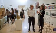 At right, Tim Forcade and Susan Tate, director of the Lawrence Arts Center, visit Thursday during a gallery opening reception of the Lawrence Arts Center Benefit Auction exhibit. Forcade has artwork in the exhibition that will run up to the auction April 14.