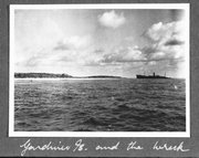 This image provided by The International Group for Historic Aircraft Recovery and displayed at a U.S. State Department news conference on Tuesday, March 20, 2012, may provide a new clue in one of the 20th century's most enduring mysteries and could soon help uncover the fate of American aviator Amelia Earhart, who went missing without a trace over the South Pacific 75 years ago, investigators said. Enhanced analysis of a photograph taken just months after Earhart's Lockheed Electra plane vanished shows what experts think may be the landing gear of the aircraft, the small black object on the left side of the image, protruding from the waters off the remote island of Nikumaroro, in what is now the Pacific nation of Kiribati. Armed with that analysis by the State Department, historians, scientists and salvagers from The International Group for Historic Aircraft Recovery, are returning to the island in July 2012 in the hope of finding the wreckage of Earhart's plane and perhaps even the remains of the pilot and her navigator Fred Noonan.