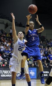 Kansas’ Angel Goodrich (3) passes over Delaware’s Lauren Carra (22) during the second half on Tuesday in Little Rock, Ark.