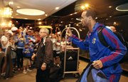 Kansas guard Travis Releford waves to a gathering of Jayhawk fans as the team arrives on Wednesday, March 21, 2012, at the Hyatt Regency St. Louis at the Arch.