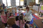 Laurie Dale Marshall, director of the Lawrence Community Nursery School, 645 Ala., reads to the children on March 27.