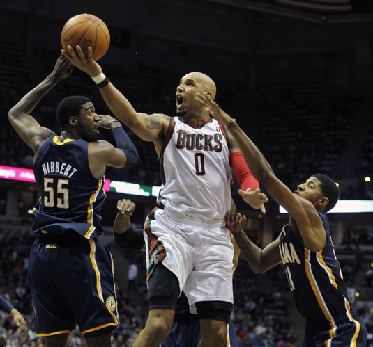 Indiana Pacers' Roy Hibbert (55) and Paul George defend as Milwaukee Bucks' Drew Gooden (0) drives to the basket during the first half of an NBA basketball game on Saturday, March 24, 2012, in Milwaukee.