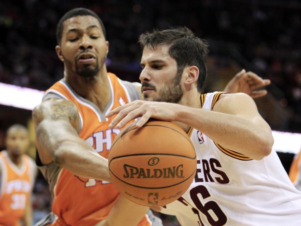 Cleveland Cavaliers' Omri Casspi, right, of Israel, drives past Phoenix Suns' Markieff Morris during the second quarter in an NBA basketball game, Sunday, March 25, 2012, in Cleveland.