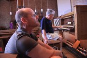 Proctor Crow, a Reuter Organ employee, plays the organ at First Presbyterian Church as Tracy Resseguie, the musical director at the church, listens March 31.