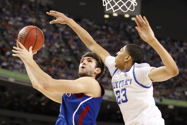 Kansas center Jeff Withey looks for a shot as Kentucky forward Anthony Davis reaches in to defend during the first half of the national championship on Monday, April 2, 2012 in New Orleans.