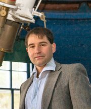 Idan Ginsburg, shown with a historic telescope at Dartmouth College in Hanover, N.H., is a 1994 graduate of Lawrence High School.