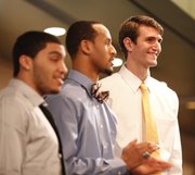 Kansas center Jeff Withey smiles as he is recognized before those gathered during the Men's Basketball Banquet on Monday, April 9, 2012 at the Holidome. Also pictured are Niko Roberts, left, and Travis Releford.