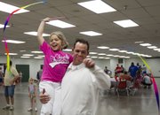 John and Sydney Delfelder try their hand at rhythmic gymnastics during the Quail Run Girl Scouts’ annual father-daughter event on Sunday in Building 21 at the Douglas County Fairgrounds, 2110 Harper St. The theme of this year’s event was the Olympics.