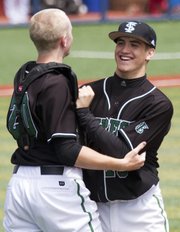 Free State catcher Lee McMahon, left, celebrates with pitcher Sam Hearnen following the Firebirds’ victory over Branson (Mo.) Saturday, April 21, 2012, at Hoglund Ballpark.