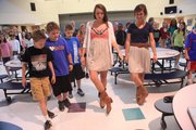 Quail Run fourth-graders Simon Zimmerman, Matthew Watson and Jacob Thompson try to stay in step while learning how to line dance with KU student teachers Katie Stearns and Mallory Bayles on Wednesday at Quail Run School. Since February, 25 KU elementary education majors have visited Quail Run’s fourth-grade class as part of their intermediate literacy class.