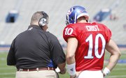 Kansas head coach Charlie Weis goes over a play with quarterback Dayne Crist during the first half of the Spring Game on Saturday, April 28, 2012 at Kivisto Field.