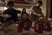 Lawrence High film teacher Jeff Kuhr, left, prepares prize bags along with LHS seniors Bailie Richards, center, and CJ Roush before the start the seventh annual Focus Film Festival on Sunday at Liberty Hall, 644 Mass. Kuhr, Richards and Roush, along with senior Laura Fleming, were responsible for organizing the event.
