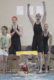 Lawrence High sophomore Annie Odrowski, second from right, gets caught up in the emotion of a come-from-behind second-place finish for the Lions as sophomore anchor Heather Cistola finishes during the Girls 400 Yard Freestyle Relay event of the Sunflower League Swimming and Diving Championships on Saturday, May 5, 2012 at Free State High School. Pictured at left is LHS sophomore Gretchen Frick, and at right is junior Miranda Rohn.
