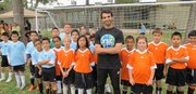 Mark Kabban, Program Coordinator for Youth and Leaders living actively, or Yalla, stands with children enrolled in YALLA. Kabban, a Baker University graduate, was named a 2012 CNN Hero earlier this month for his work with YALLA and refugee children in the San Diego area.
