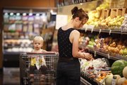 Megan Hemphill, Lawrence, browses the selection of fruit as she shops for groceries with her daughter, Lena, on Tuesday, May 22, 2012, at The Merc, 901 Iowa.