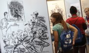 Alia Akkerman, an incoming senior at Gardner-Edgerton High School, looks through an exhibit featuring the work of famous political cartoonist Herbert Block — “Herblock” — on Tuesday at the Dole Institute of Politics. Akkerman and other students participating in the Rotary Youth Leadership Academy toured the Dole Institute as part of the leadership camp, which works to promote leadership, community service and civic engagement.