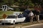 Officers search a vehicle pulled over on the north side of Sixth Street near the intersection of Sixth Street and Lawrence Avenue on Wednesday. Authorities were rounding up suspects connected to a four-year investigation into marijuana trafficking.