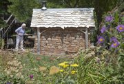 Marilyn Clark had an outdoor oven constructed by area stonemason Keith Middlemas for her backyard patio. The cottage structure includes a wood-fired oven and a built-in slide out grill. Clark says she cooks in it often in the summer because it doesn’t heat up the house.