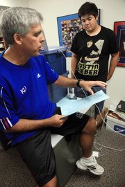 KU debate coach Scott Harris works with Hunter Goh, of Bakersfield, Calif., at KU's Debate Camp in early July. Harris runs several camps every year for high school debaters, in addition to his regular college-level teaching and coaching duties.