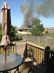 Picture submitted via Twitter of grass fire threatening homes near Langston Hughes School in Lawrence on George Williams Way. Photo is from a backyard in 1000 block of Stonecreek Drive.