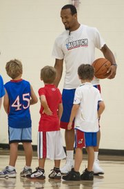 Kansas senior guard Travis Releford chats with some of the smaller participants of the Cole Aldrich basketball camp Monday, July 9, 2012, at Olathe Northwest High School.
