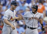 All-Star MVP Melky Cabrera, right, of the San Francisco Giants, celebrates his two-run, fourth-inning home run with the Cardinals’ Matt Holliday. Cabrera helped the NL to an 8-0 rout of the AL in the All-Star game on Tuesday, July 10, 2012, in Kansas City, Mo.