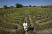 David Bartholomew is pictured before a labyrinth created he created with his wife, Joan Clark, at 1661 E. 400 Road, west of Lawrence. Bartholomew hopes the labyrinth will be used as a place of meditation.