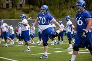 Kansas offensive lineman Gavin Howard stretches out as the team warms up during practice on Thursday, Aug. 2, 2012.