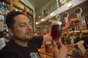 IAN SUTOMAYORA SERVES UP A BEER at Free State Brewery, 636 Mass. The brewery was voted Best Restaurant and Best Bar in the 2011 Best of Lawrence contest.