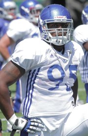 Defensive end Josh Williams, a fifth-year senior who played three years at Nebraska, takes a break during practice Monday, Aug. 6, 2012, at the KU practice fields.